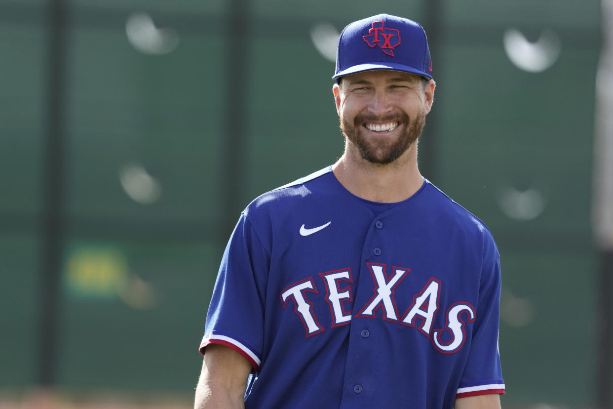 Texas Rangers pitcher Jacob deGrom waits to throw during spring training baseball practice Sunday, Feb. 19, 2023, in Surprise, Ariz. (AP Photo/Charlie Riedel)