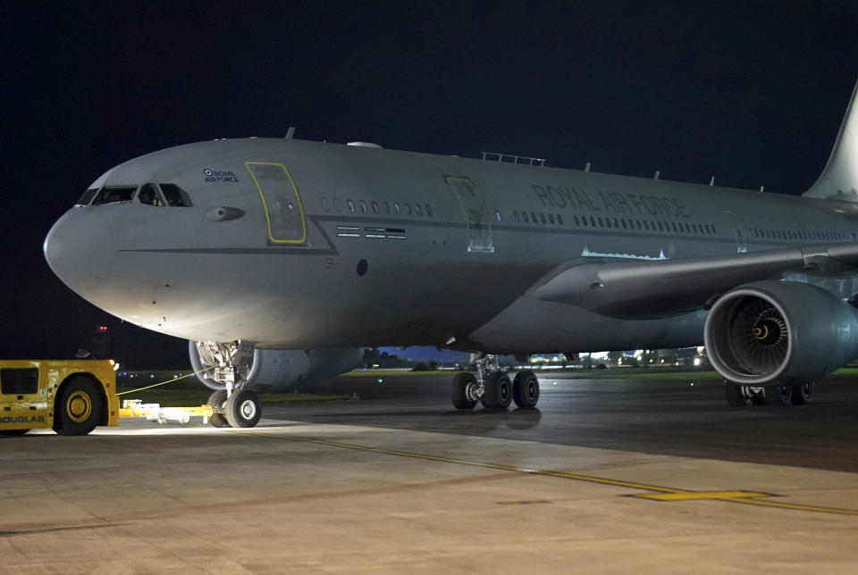 An RAF flight from Afghanistan arrives at RAF Brize Norton air base in England late Tuesday Aug. 17, 2021. The plane carrying more British nationals and Afghans from Afghanistan landed at Brize Norton on Tuesday night, as the evacuation process continued. (Christopher Furlong/Pool via AP)