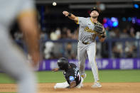 Pittsburgh Pirates second baseman Jared Triolo (19) throws to first to put out Miami Marlins' Avisail Garcia after tagging second to put out Tim Anderson for the double play during the fourth inning of a baseball game, Friday, March 29, 2024, in Miami. (AP Photo/Wilfredo Lee)