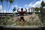 An Afghan bodybuilder poses after competing in a contest in Kabul, where the sport has become ubiquitous since the fall of the Taliban regime