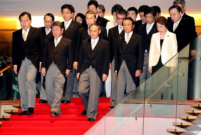 Japan's newly appointed PM Suga attends a photo session with his cabinet members in Tokyo