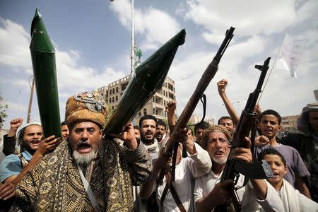 Houthi followers hold mock missiles and their rifles as they shout slogans during a demonstration against the United Nations in Sanaa, Yemen, July 5, 2015. REUTERS/Mohamed al-Sayaghi