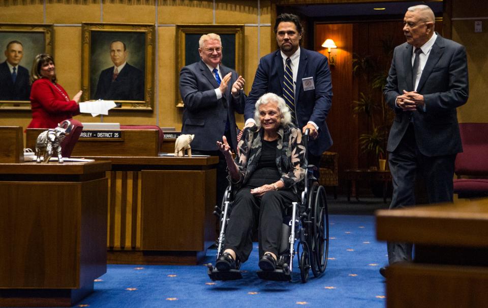 Retired Supreme Court Justice Sandra Day O'Connor enters the Senate Chambers, along with former state Sen. Alfredo Gutierrez (right) on March 15, 2017.