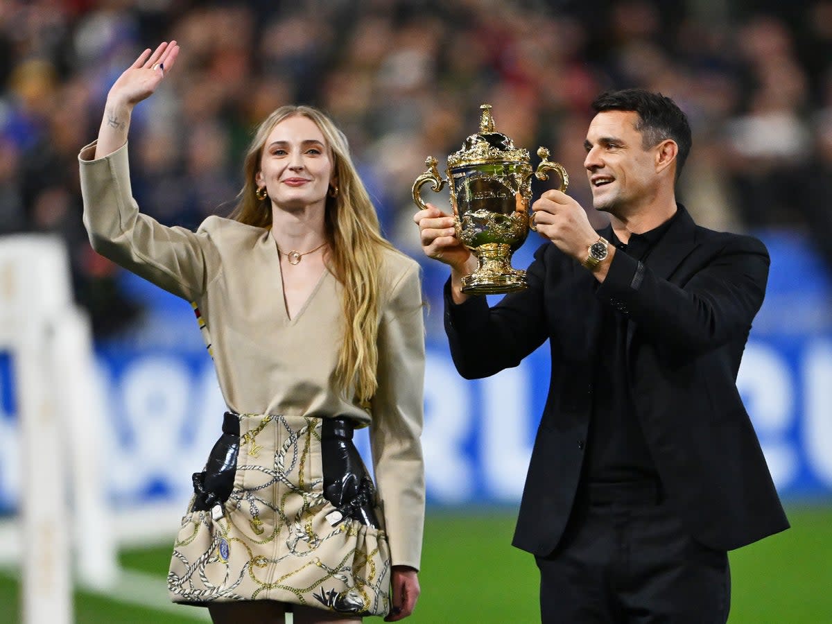 Dan Carter and Sophie Turner lift The Webb Ellis Cup at the 2023 Rugby World Cup final in Paris (Getty Images)