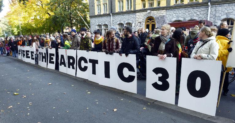 Greenpeace supporters hold placards reading "Free the Arctic 30" in support of 30 activists jailed by Russia in Helsinki on October 5, 2013