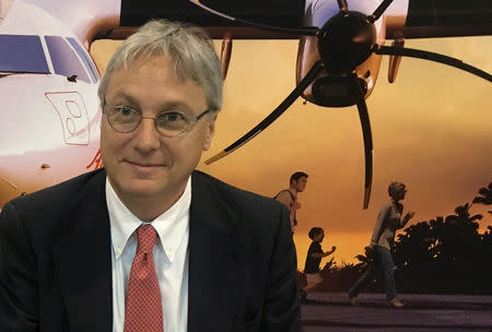 FILE PHOTO: ATR's Chief Executive Officer Christian Scherer, signs a deal for 4 ATR 72-600s at a ceremony at the Singapore Airshow in Singapore, February 7, 2018. REUTERS/Brenda Goh/File Photo