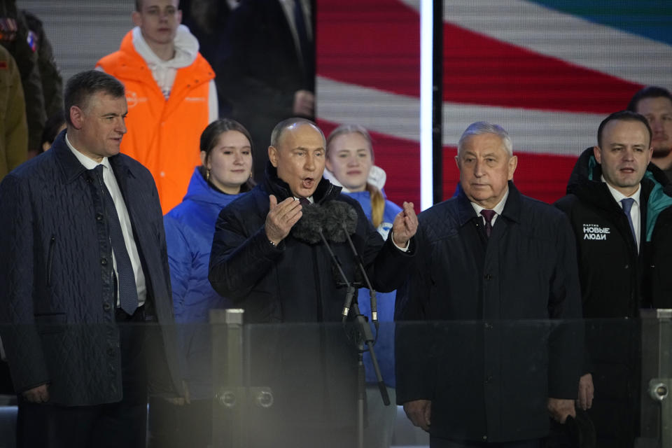 Russian President Vladimir Putin, 2nd left, speaks at a concert marking his victory in a presidential election and the 10-year anniversary of Crimea's annexation by Russia on Red Square in Moscow, Russia, Monday, March 18, 2024, together with candidates who ran in the Russian presidential elections, Leonid Slutsky, left, Vladislav Davankov, right, and Nikolai Kharitonov, 2nd right. President Vladimir Putin seized Crimea from Ukraine a decade ago, a move that sent his popularity soaring but was widely denounced as illegal. (AP Photo/Alexander Zemlianichenko)