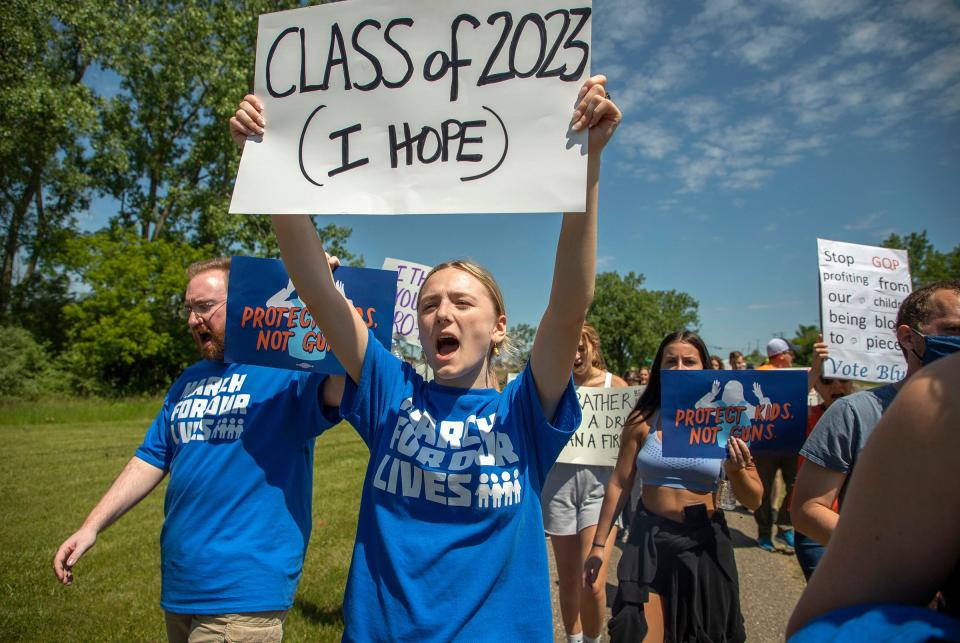 Alexandra Aris, 16, center, will be a senior in the 2023 class at Clarkston High School, carries a sign along with marchers as they march in the March For Our Lives Oxford event on Saturday, June 11, 2022. Students, teachers and parents shared their stories of loss following the shooting at the school and demanded that lawmakers enact gun control laws to keep these tragedies from happening again. When the crowd reached the high school, it held a moment of silence to honor and remember the teens who were gunned down, Madisyn Baldwin, Tate Myre, Justin Shilling, and Hana St. Juliana.