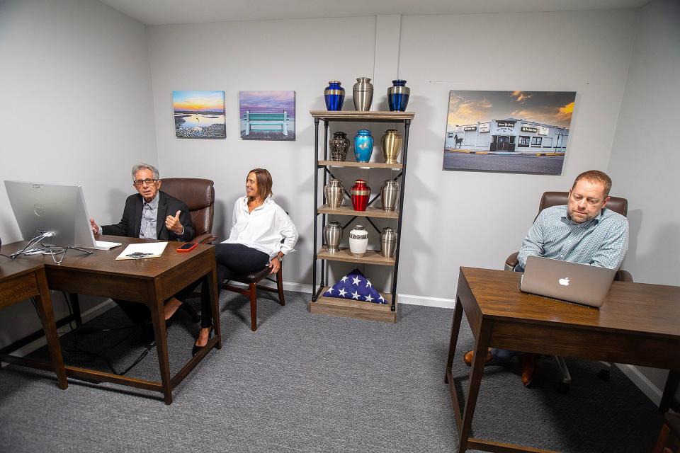 Robert DeSevo, funeral director, Stephanie DeSevo, manager, and Walter Bilotta, funeral director, discuss their business and display urns for sale at Direct Cremations in Neptune, NJ Monday, September 18, 2023.