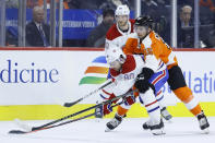 Philadelphia Flyers' Matt Niskanen (15) battles for the puck with Montreal Canadiens' Tomas Tatar (90) during the second period of an NHL hockey game, Thursday, Jan. 16, 2020, in Philadelphia. (AP Photo/Matt Slocum)