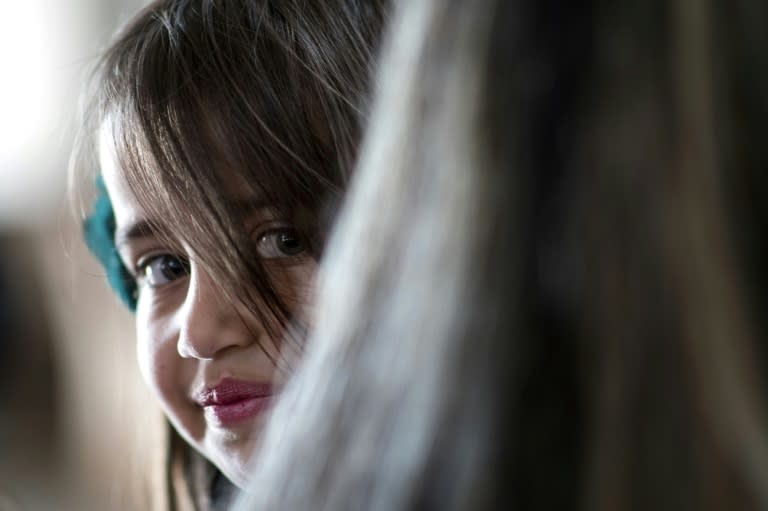 An Iraqi Christian girl smiles during Easter mass at the Mar Yohanna church in the predominantly Christian Iraqi town of Qaraqosh on April 16, 2017