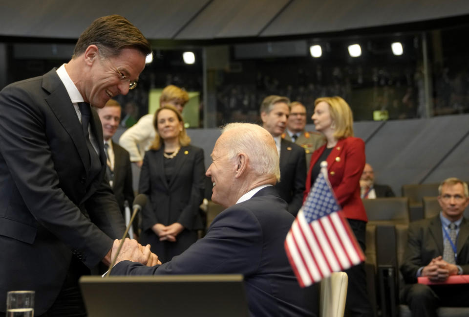 FILE - U.S. President Joe Biden, center, greets Netherland's Prime Minister Mark Rutte, left, prior to a round table meeting during an extraordinary NATO summit at NATO headquarters in Brussels, Thursday, March 24, 2022. NATO is set to celebrate on Thursday, April 4, 2024, 75 years of collective defense across Europe and North America as Russia's war on Ukraine enters its third year. (AP Photo/Markus Schreiber, File)