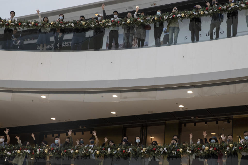 People hold up their hands to represent their five demands of the protests and chant "Pass the bill, save Hong Kong" at the IFC mall in Hong Kong on Thursday, Nov. 21, 2019. Pressure ratcheted up on Hong Kong as the U.S. Congress approved legislation late Wednesday to sanction officials who carry out human rights abuses and require an annual review of the favorable trade status that Washington grants Hong Kong. Another bill bans export of tear gas and other non-lethal tools to Hong Kong,(AP Photo/Ng Han Guan)