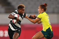 <p>CHOFU, JAPAN - JULY 30: Roela Radiniyavuni of Team Fiji puts a fend on Charlotte Caslick of Team Australia in the Womenâs Quarter Final match between Team Fiji and Team Australia during the Rugby Sevens on day seven of the Tokyo 2020 Olympic Games at Tokyo Stadium on July 30, 2021 in Chofu, Tokyo, Japan. (Photo by Dan Mullan/Getty Images)</p> 