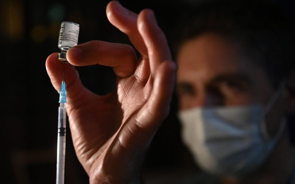 A doctor administers the Pfizer-BioNTech vaccine at a vaccination centre in Salisbury Cathedral - NEIL HALL/EPA-EFE/Shutterstock