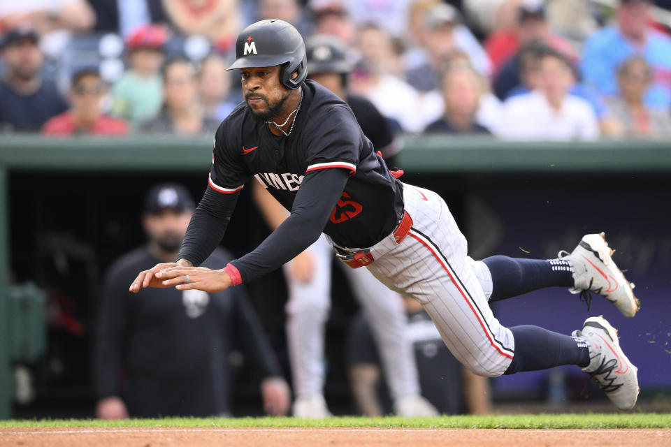 Minnesota Twins' Byron Buxton starts his slide toward home on a double by teammate Willi Castro during the second inning of a baseball game against the Washington Nationals, Monday, May 20, 2024, in Washington. Buxton was tagged out at home by Nationals catcher Keibert Ruiz. (AP Photo/Nick Wass)
