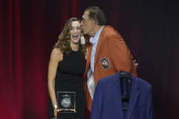 Two-time NBA champion coach Rudy Tomjanovich kisses one of his daughters at the 2020 Basketball Hall of Fame awards tip-off celebration and awards gala, Friday, May 14, 2021, in Uncasville, Conn. (AP Photo/Kathy Willens)