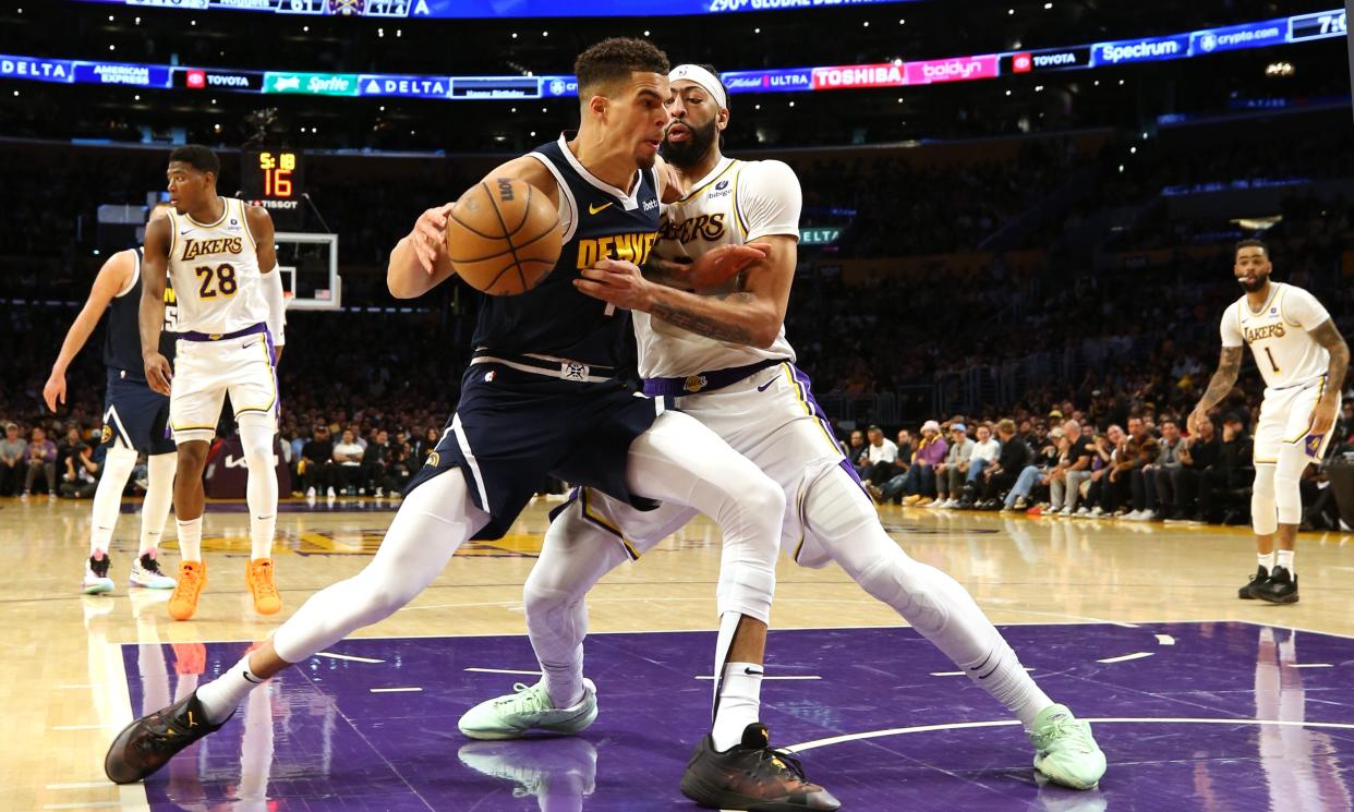 Apr 27, 2024; Los Angeles, California, USA; Denver Nuggets forward Michael Porter Jr. (1) battles for position with Los Angeles Lakers forward Anthony Davis (3) during the third quarter in game four of the first round for the 2024 NBA playoffs at Crypto.com Arena. Mandatory Credit: Jason Parkhurst-USA TODAY Sports