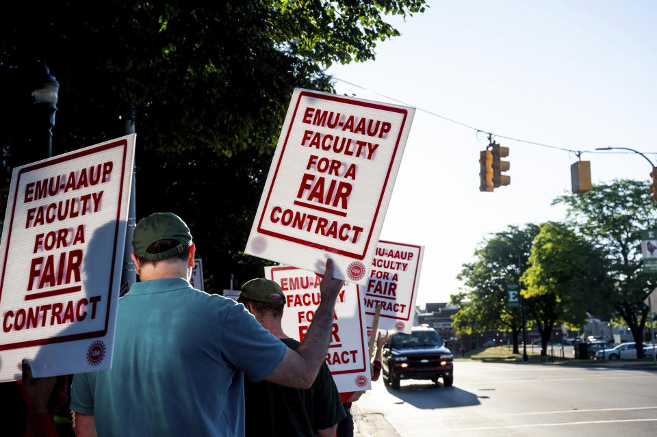 Eastern Michigan University faculty strike outside Welch Hall along Cross Street in Ypsilanti on Wednesday, Sept. 7, 2022. Several dozen faculty at Eastern Michigan University began a strike Wednesday after their union and the school's administration failed to agree on a new labor contract. (Jacob Hamilton/Ann Arbor News via AP)