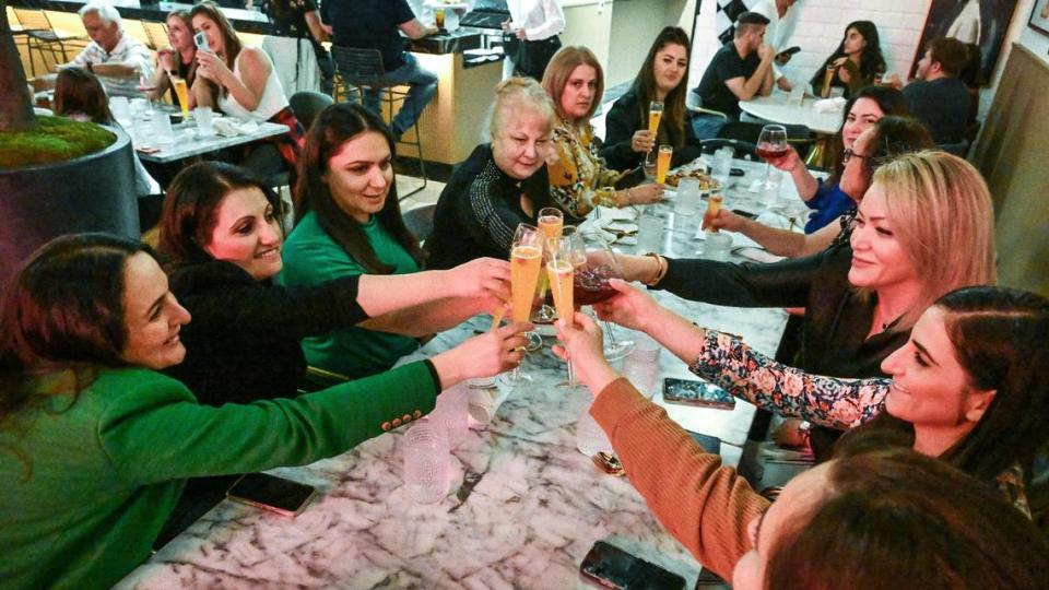 Friends toast each other with mimosas during a test run for The Brunch Bar restaurant in the Clovis Commons shopping center at Herndon and Willow avenues on Tuesday, May 9, 2023.