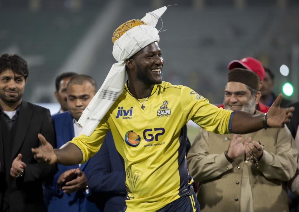 Former West Indies captain Darren Sammy gestures wearing a traditional turban at Gaddafi stadium in Lahore, Pakistan, Sunday, March 5, 2017. Sammy led Peshawar Zalmi to the Pakistan Super League Twenty20 title with a 58-run victory against Quetta Gladiators in a trouble-free final on Sunday. (AP Photo/K.M. Chaudary)