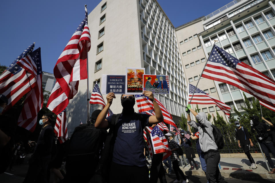 Protesters carrying American flags march to U.S. Consulate during a rally in Hong Kong, Sunday, Dec. 1, 2019. Hong Kong protesters carrying American flags and banners appealing to President Donald Trump rallied in the semi-autonomous Chinese territory. (AP Photo/Vincent Thian)