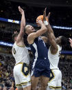 CORRECTS DAY/DATE TO SUNDAY, MARCH 12 INSTEAD OF SATURDAY, MARCH 11 - Penn State's Seth Lundy drives to the basket as Purdue's Mason Gillis (0) and Brandon Newman defend during the second half of an NCAA college basketball championship game at the Big Ten men's tournament, Sunday, March 12, 2023, in Chicago. (AP Photo/Erin Hooley)