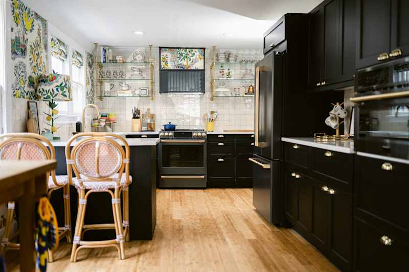 Glass cabinets in newly renovated kitchen with black cabinets.