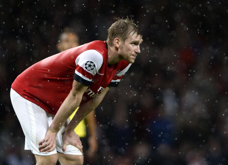 Arsenal's Per Mertesacker reacts after being defeated by Borussia Dortmund in their Champions League soccer match at the Emirates stadium in London October 22, 2013. REUTERS/Dylan Martinez (BRITAIN - Tags: SPORT SOCCER)