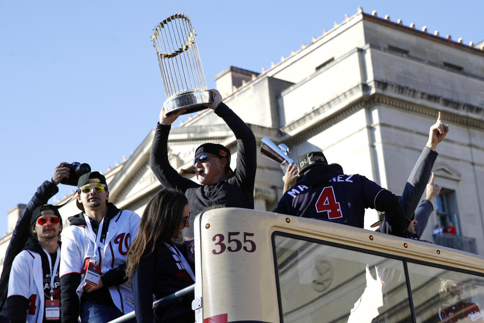 Washington Nationals general manager Mike Rizzo holds up the World Series trophy during a parade to celebrate the team's World Series baseball championship over the Houston Astros, Saturday, Nov. 2, 2019, in Washington. (AP Photo/Patrick Semansky)