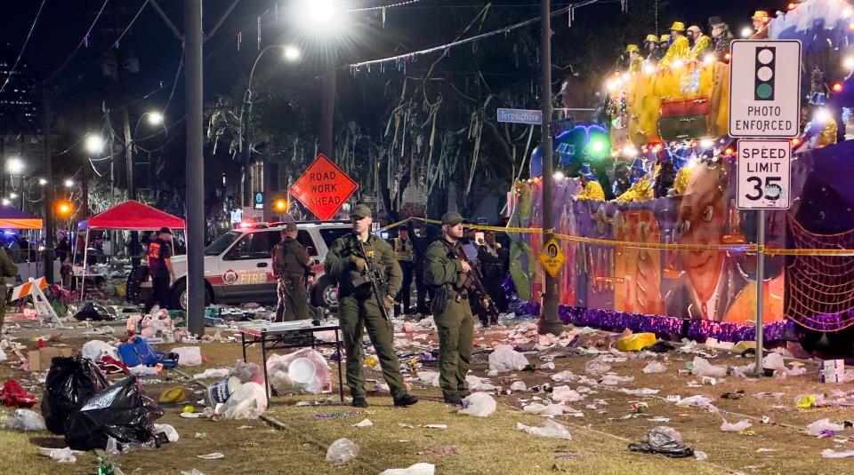 Police work the scene of a shooting at the Krewe of Bacchus parade on Sunday, Feb. 19, 2023.  Five people were shot, including a young girl, during a Mardi Gras parade in New Orleans, police said, and a suspect was in custody.