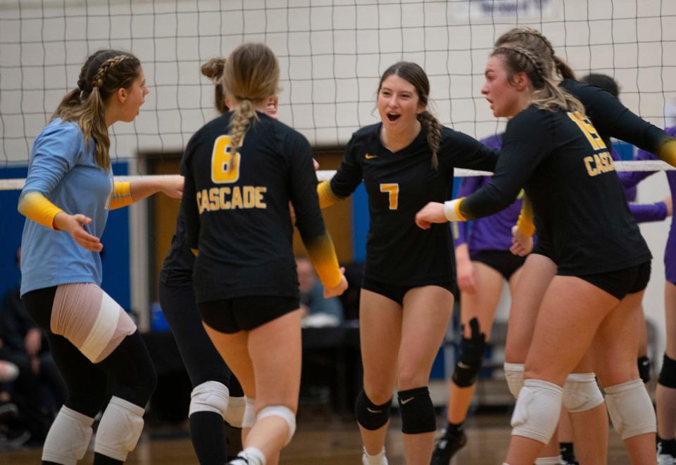 Cascade's Tayler Kamm, center, joins teammates in celebration during their match against Marshfield in the 4A volleyball state championships in Springfield.