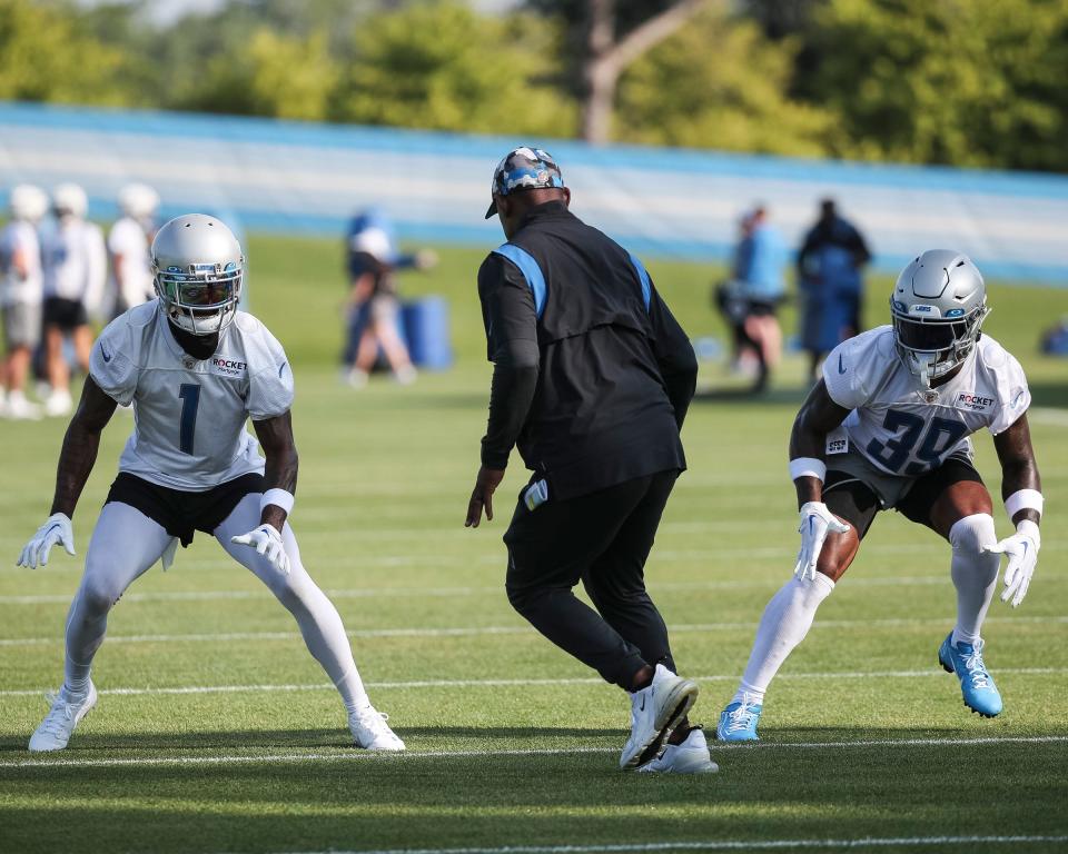 Detroit Lions cornerback Cam Sutton, left, and cornerback Jerry Jacobs, right, practice with cornerbacks coach Dré Bly during training camp at Detroit Lions Headquarters and Training Facility in Allen Park on Monday, July 24, 2023.