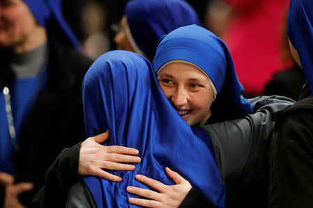 Nuns hug after the Easter vigil Mass in Saint Peter's Basilica at the Vatican, April 20, 2019. REUTERS/Remo Casilli