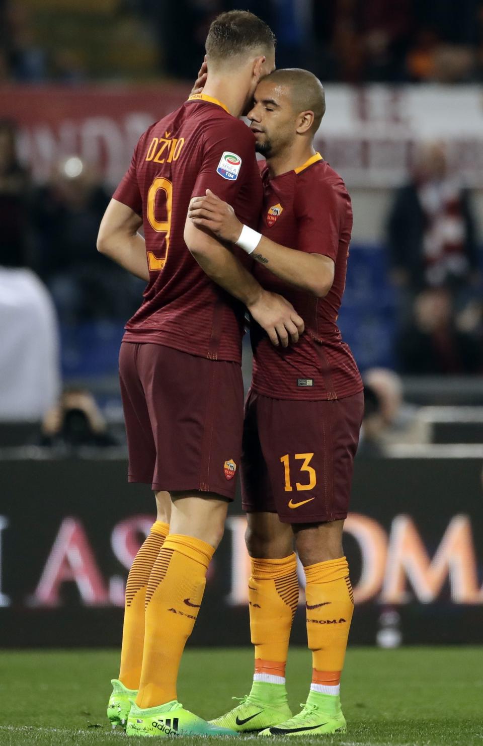 Roma's Edin Dzeko, left, celebrates with teammate Bruno Peres after scoring his side's second goal during a Serie A soccer match between Roma and Empoli, at the Rome Olympic stadium, Saturday, April 1, 2017. (AP Photo/Alessandra Tarantino)