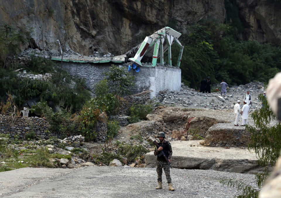 Security personnel stand guard at the site of suicide bomber attack inside a roadside mosque in the Khyber district in Khyber Pakhtunkhwa province, of Pakistan, Tuesday, July 25, 2023. A suicide bomber blew himself up inside a roadside mosque when a police officer tried to arrest him after a chase in northwestern Pakistan near the Afghan border on Tuesday, killing the officer, police said. (AP Photo/Muhammad Sajjad)