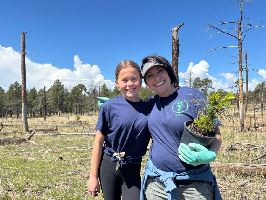 Teacher Natalie Reucker smiles for a photograph with Evey Debelak during the planting activity Thursday morning. 