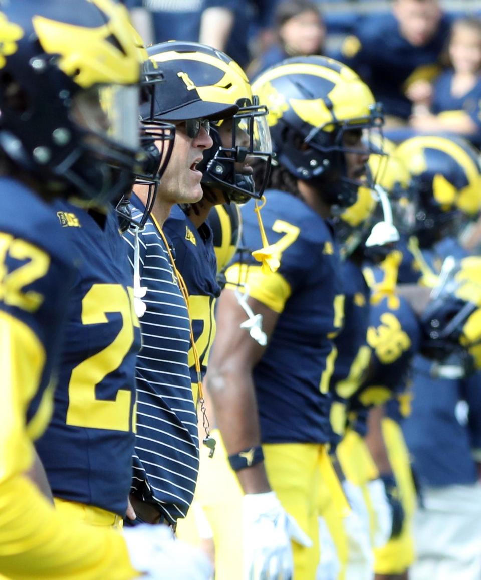 Michigan coach Jim Harbaugh watches his team warm up before action against the Rutgers at Michigan Stadium in Ann Arbor on Saturday, Sept. 23, 2023. This was Harbaugh's first game back on the sideline after a three-game suspension.