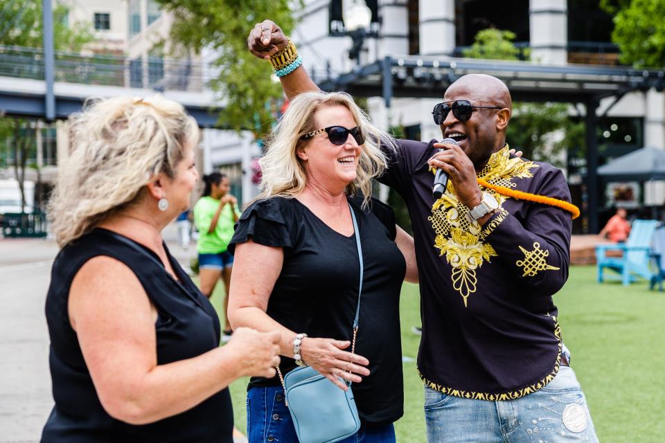 Alex Boye performs in front of Michell Duffin and Natalie Salisbury, right to left, during the Juneteenth celebration at The Gateway in Salt Lake City on June 19, 2023. | Ryan Sun, Deseret News