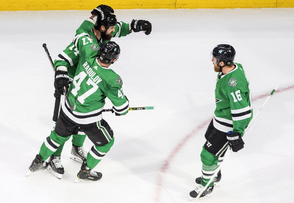 Dallas Stars' Jamie Benn (14) celebrates his goal against the Vegas Golden Knights with teammates Alexander Radulov (47) and Joe Pavelski (16) during second-period NHL Western Conference final playoff game action in Edmonton, Alberta, Saturday, Sept. 12, 2020. (Jason Franson/The Canadian Press via AP)