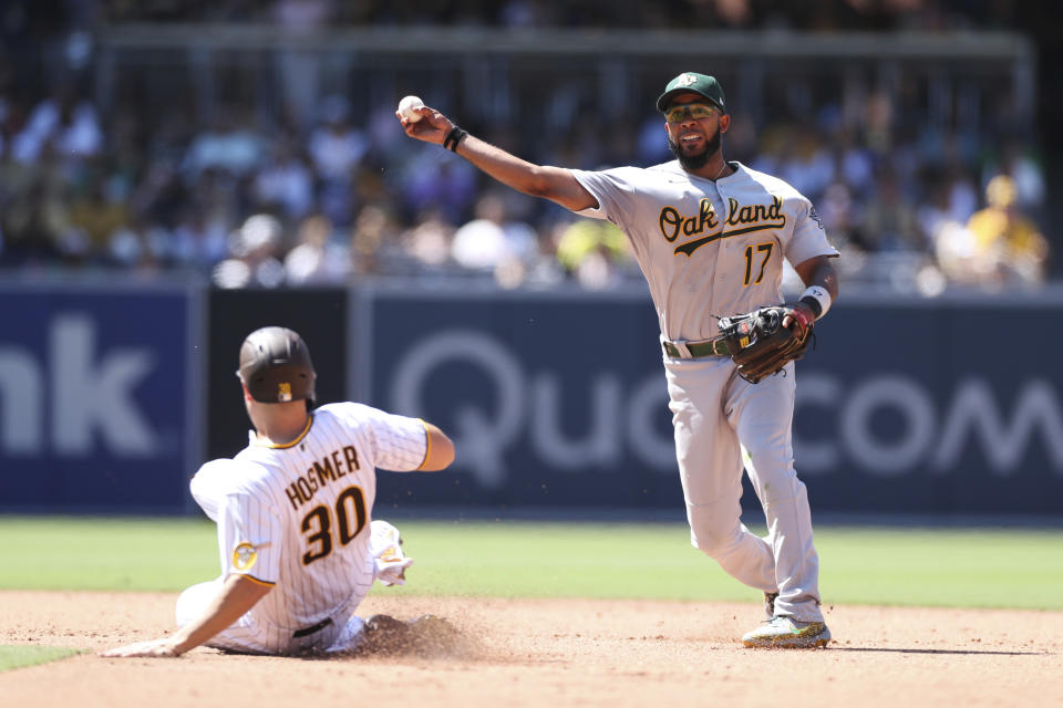 Oakland Athletics shortstop Elvis Andrus (17) prepares to throw to first to attempt a double play after forcing out Eric Hosmer (30) at second base on a ball hit by Adam Frazier during the sixth inning of a baseball game Wednesday, July 28, 2021, in San Diego. (AP Photo/Derrick Tuskan)