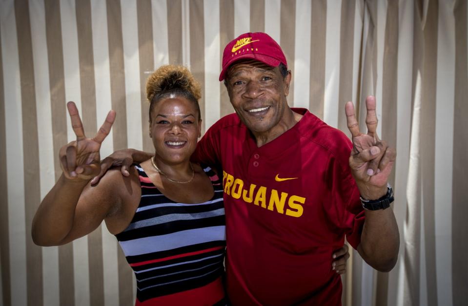 USC Heisman winner Charles White and his daughter, Tara White, show their Trojans spirit.