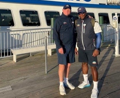 From Left: Chris Shepler, a third generation owner of Shepler's Ferry that carries tourists to Mackinac Island, is standing with Moshell Nelson, the dock lead on the Mackinac Island dock, on Oct. 14, 2021.