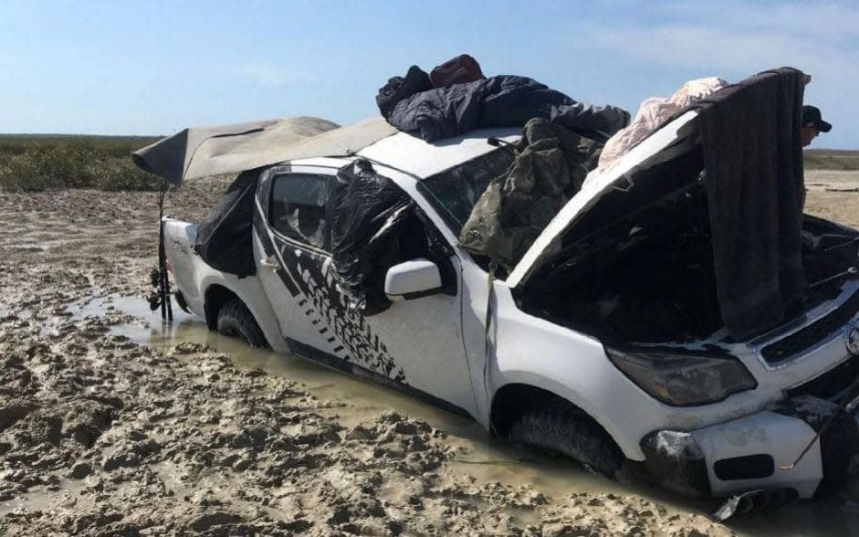 Two men stranded for days in crocodile-infested waters in Western Australia were forced to sleep on the roof of their car