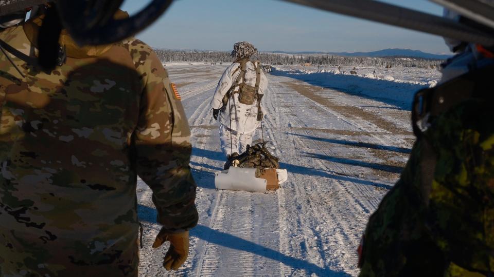 A U.S. Army paratrooper from the 11th Airborne Division leaves Donnelly Drop Zone, dragging a new jumpable sled as part of Joint Pacific Multinational Readiness Center 24-02 at Donnelly Training Area, Alaska, Feb 8, 2024.