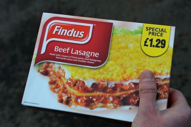 A man poses holding a Findus beef lasagne frozen ready meal near Sunderland on February 8, 2013.The Europe-wide scandal over horsemeat sold as beef spread Sunday as six French retailers pulled products from their shelves and France promised to have the results of an urgent inquiry within days