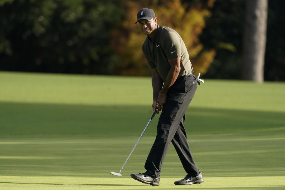 Tiger Woods watches his ball as he misses a birdie putt on the eighth hole during the first round of the Masters golf tournament Thursday, Nov. 12, 2020, in Augusta, Ga. (AP Photo/Charlie Riedel)