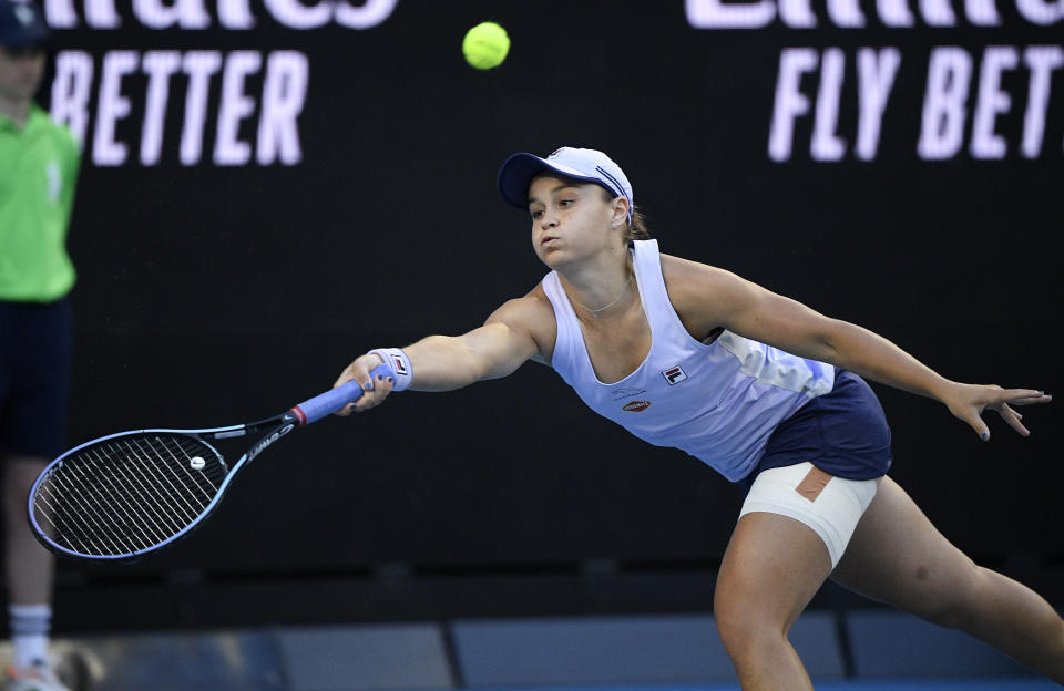 Australia's Ash Barty hits a forehand return to Russia's Ekaterina Alexandrova during their third round match at the Australian Open tennis championship in Melbourne, Australia, Saturday, Feb. 13, 2021.(AP Photo/Andy Brownbill)