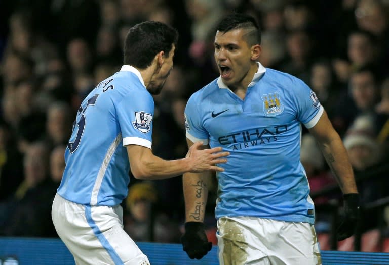 Manchester City striker Sergio Aguero (R) celebrates with teammate Jesus Navas after scoring their second goal during the Premier League match against Watford at Vicarage Road Stadium on January 2, 2016