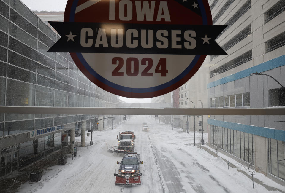 Plow trucks clear Grand Avenue as high winds and snow from winter storm Gerri four days before the Iowa caucuses on January 12, 2024 in Des Moines, Iowa.  / Credit: Chip Somodevilla / Getty Images